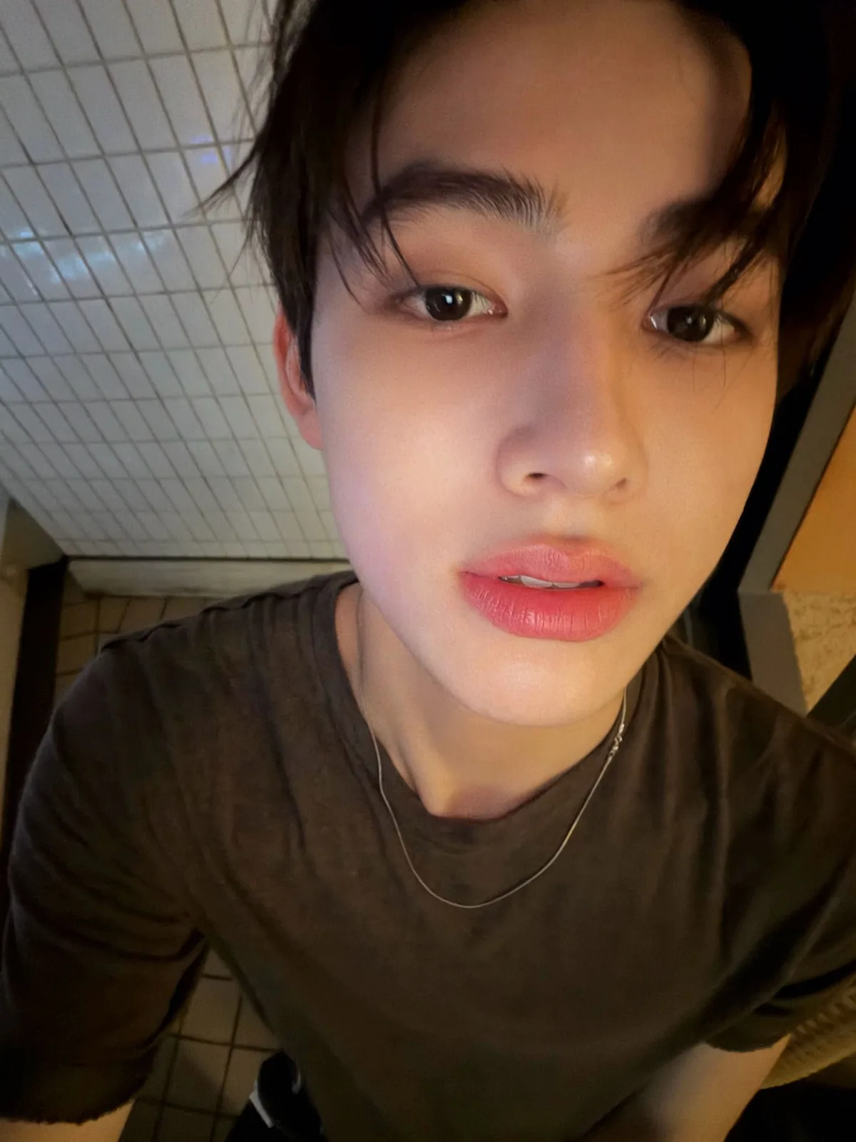 Close-up selfie in a dark tee